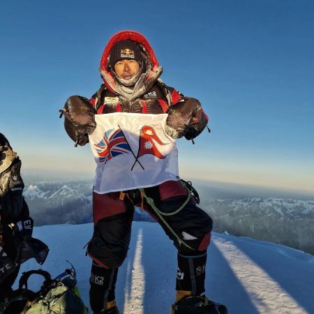 Nirmal Purja showing the flag of UK and Nepal at Mount K2 